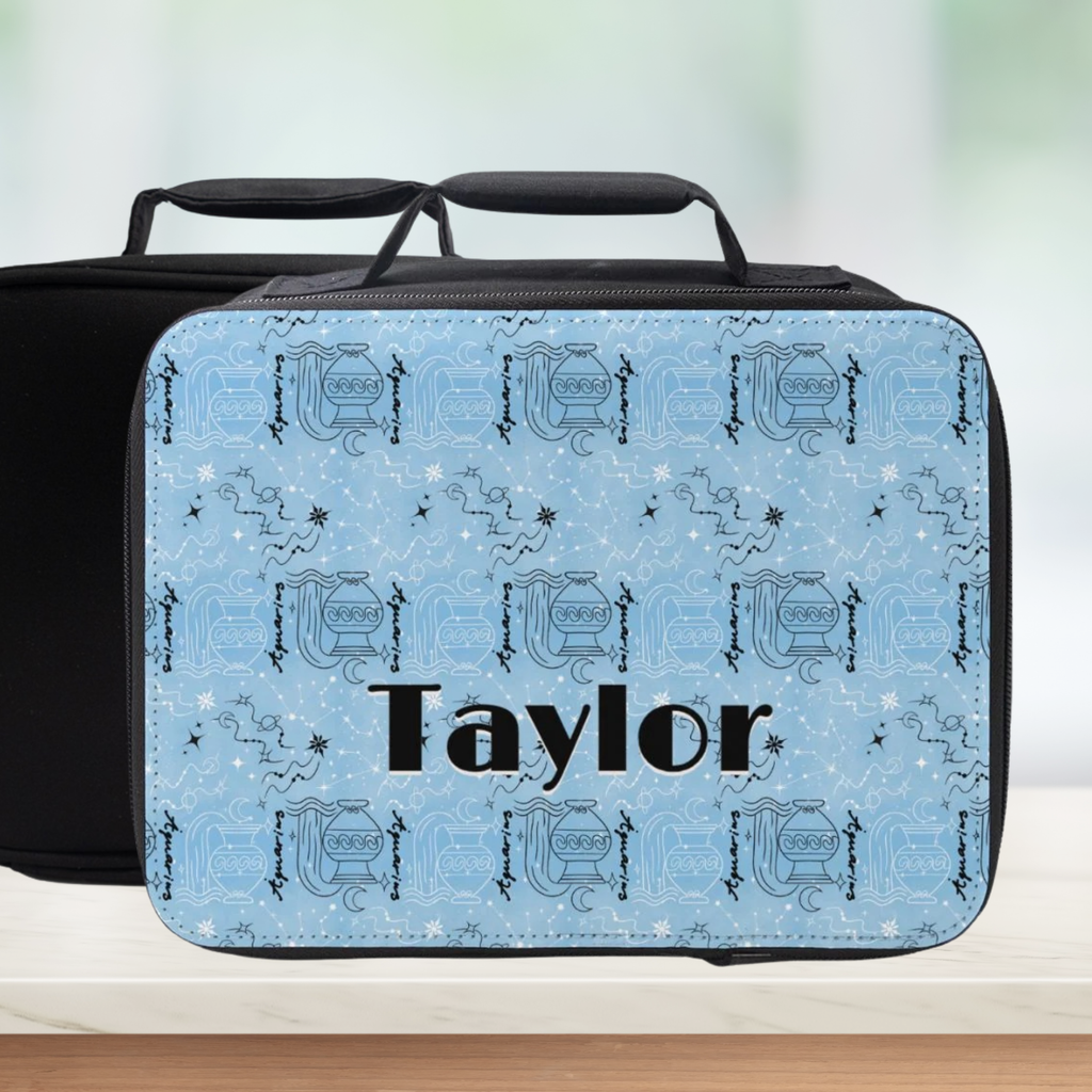 Blue and black Aquarius zodiac pattern lunch bag with 'Taylor' custom text on a blurred background