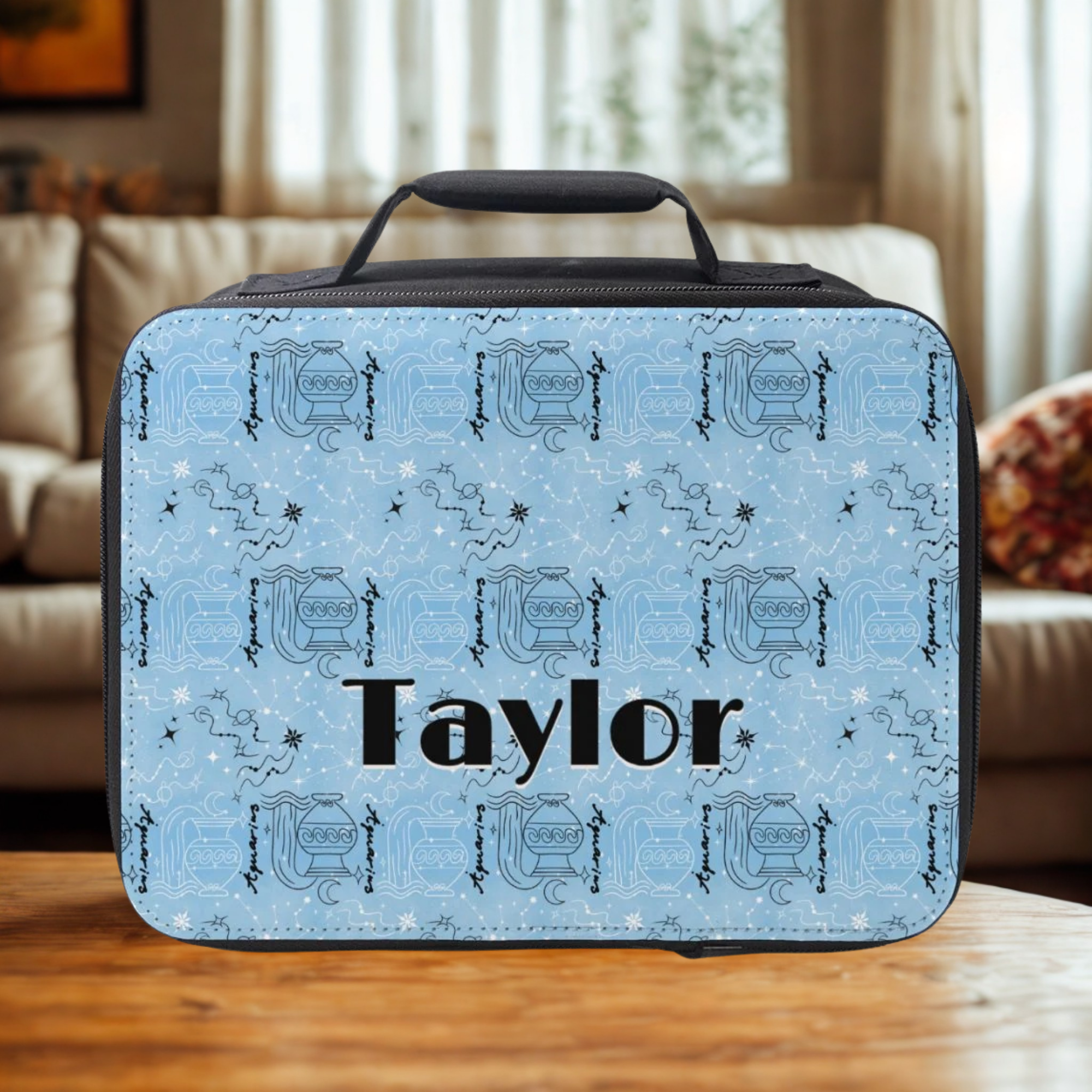 Blue patterned lunch bag with 'Taylor' on a wooden table in a living room setting