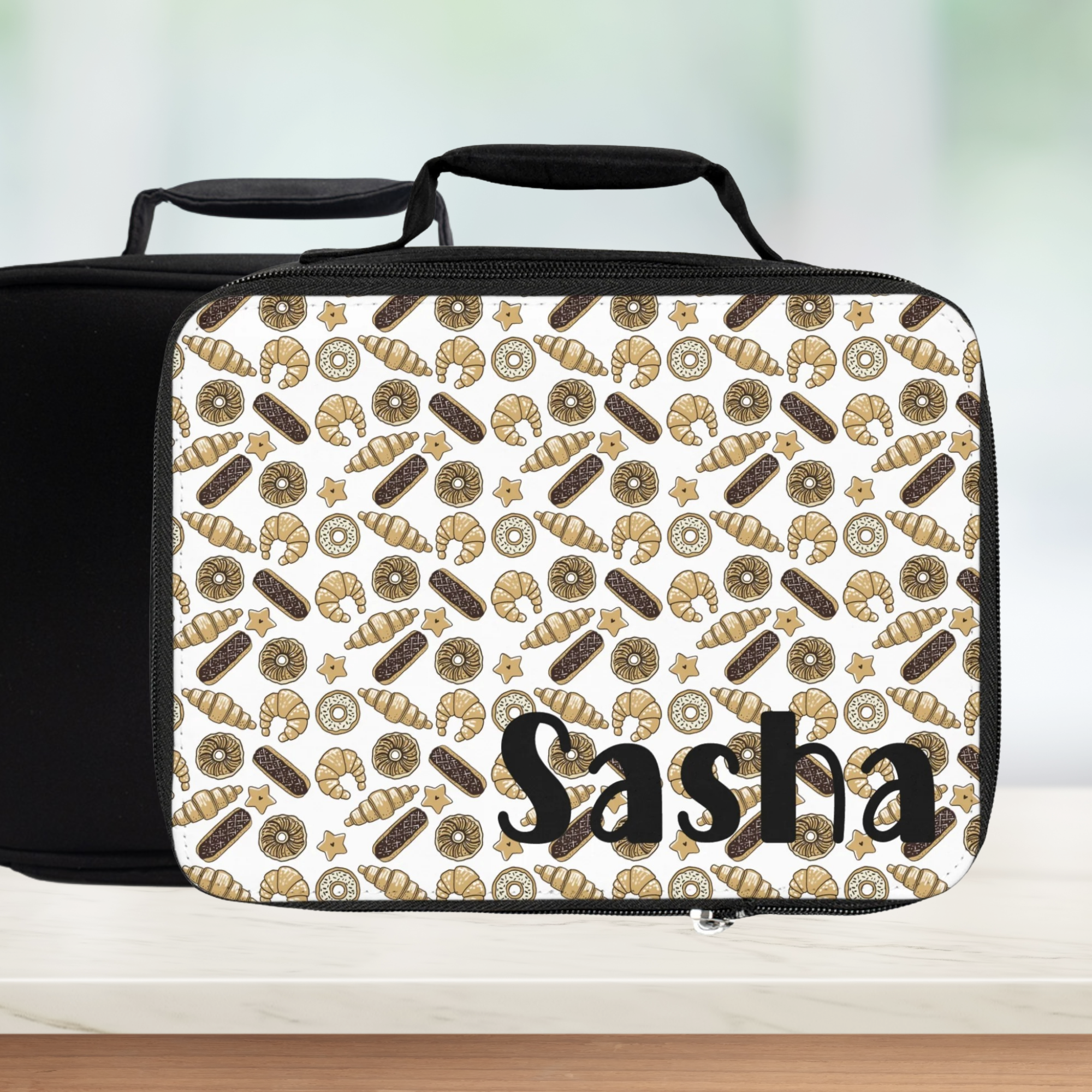 Lunch bag with donut pattern and 'Sasha' text on a white background