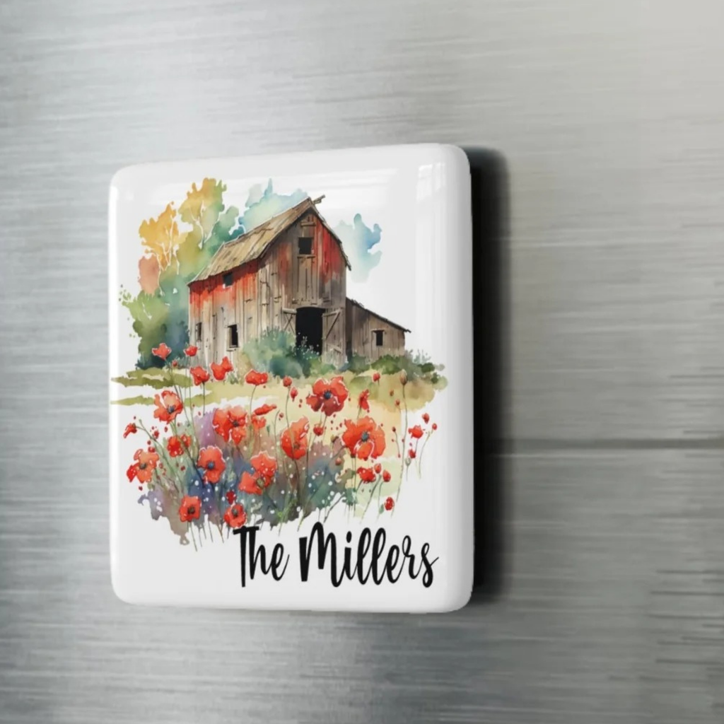 Decorative porcelain magnet  with a barn and flowers design and 'The Millers' text on a metallic background