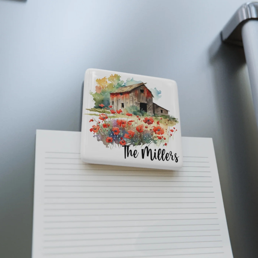 Personalized refrigerator magnet with a barn and flower design on a gray surface