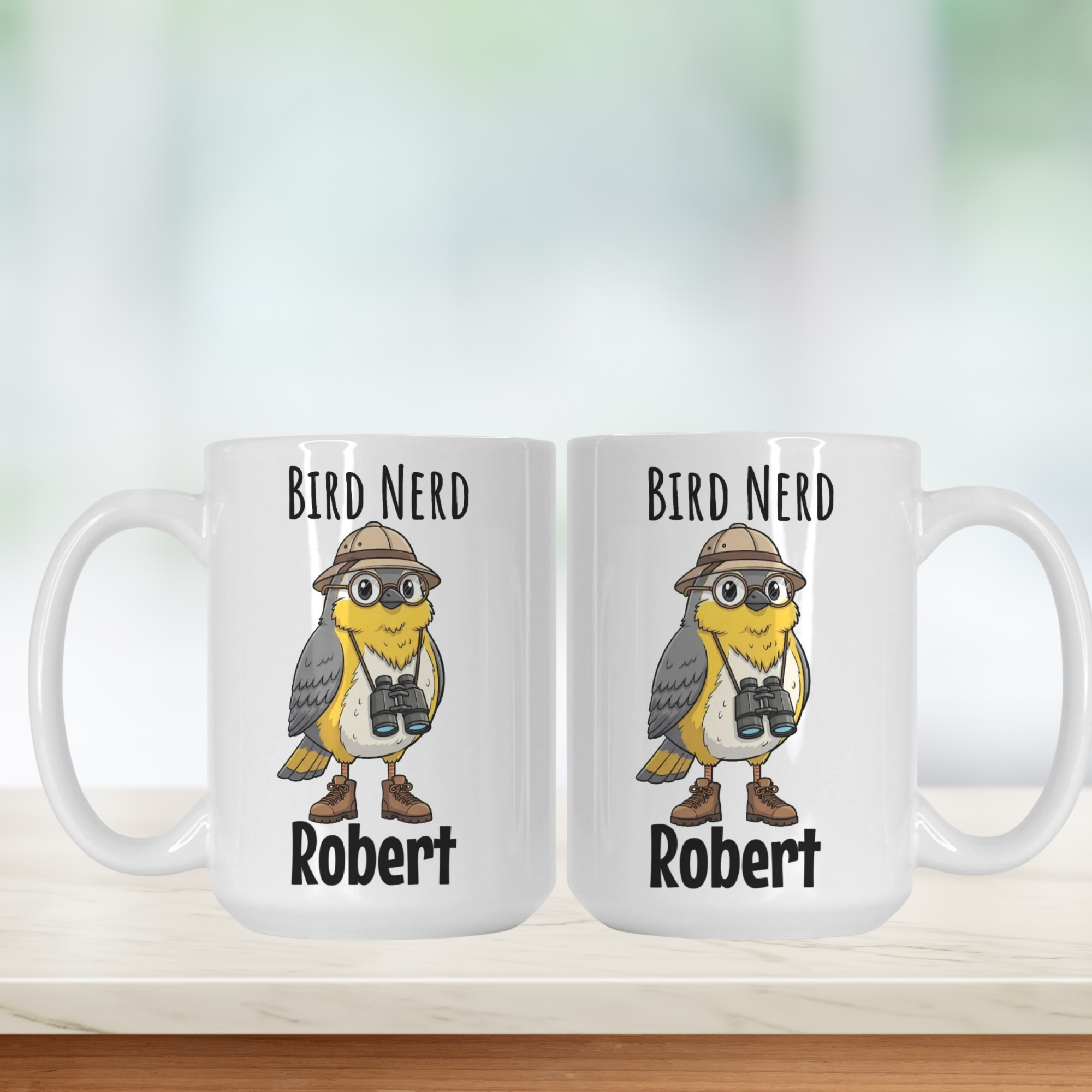 Two white mugs with a cartoon bird wearing binoculars and a hat, labeled 'Bird Nerd Robert', on a light background.