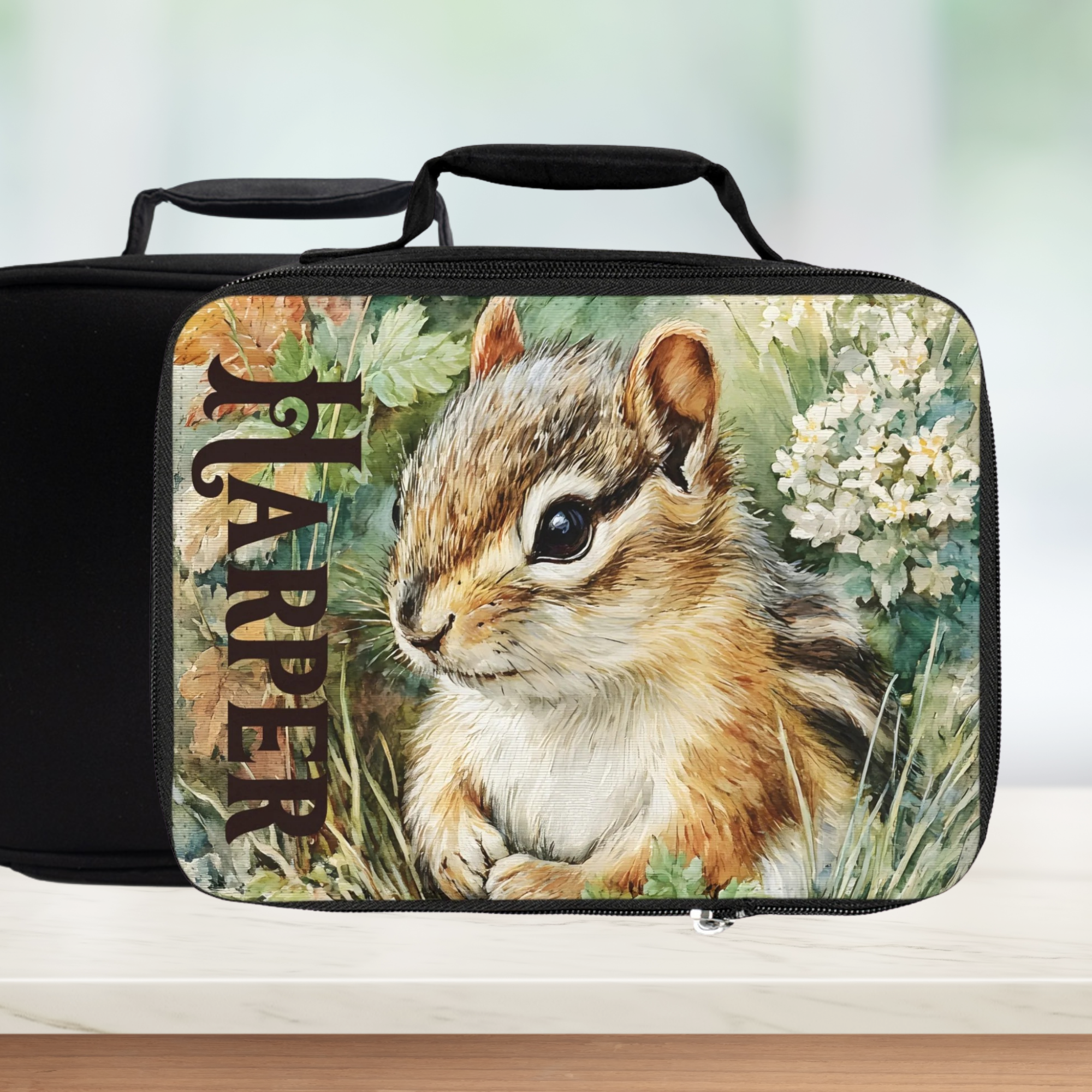 Black lunch bag with a chipmunk design and 'Harper' custom text on a white background