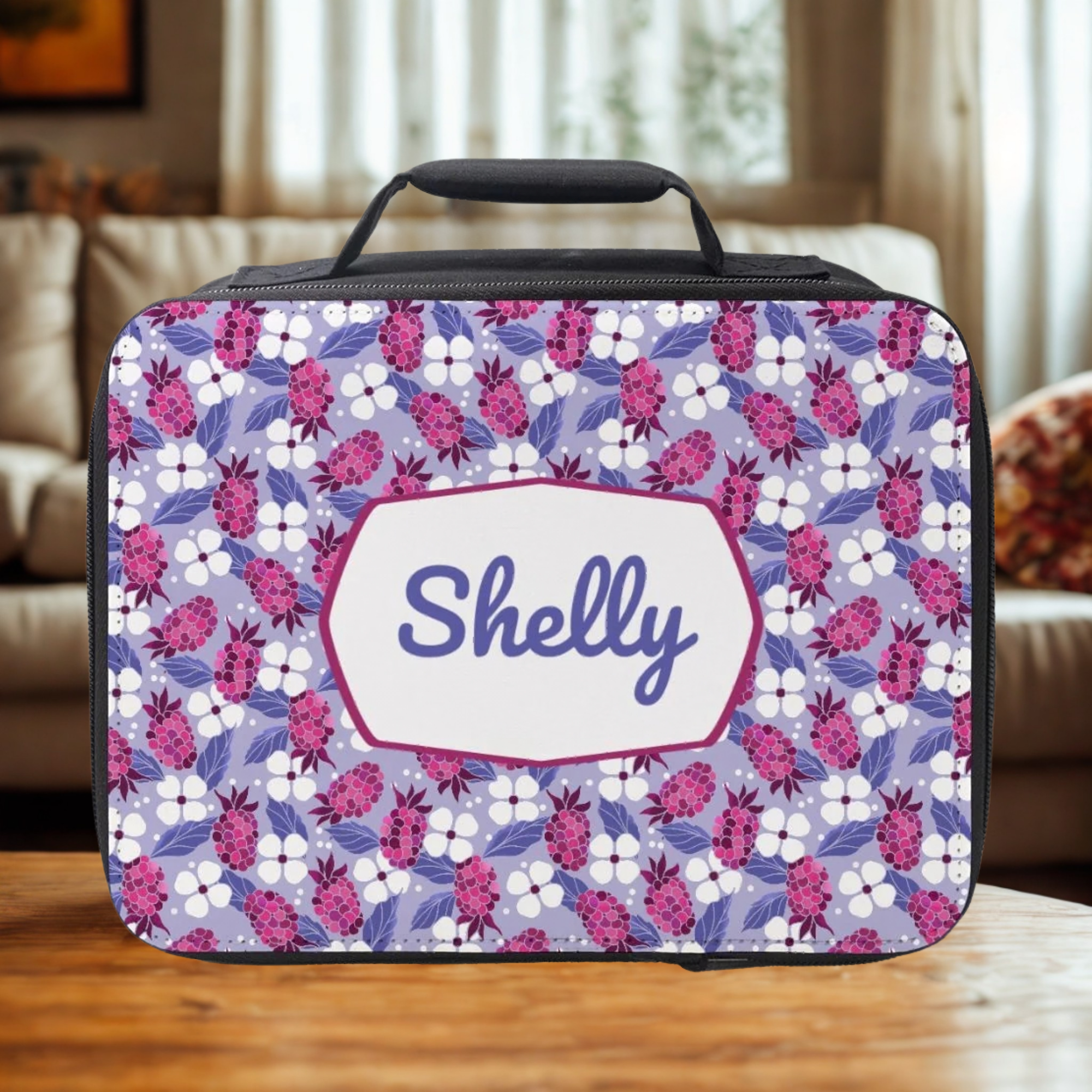 Floral patterned lunch bag with 'Shelly' personalized text on a wooden table in a cozy living room