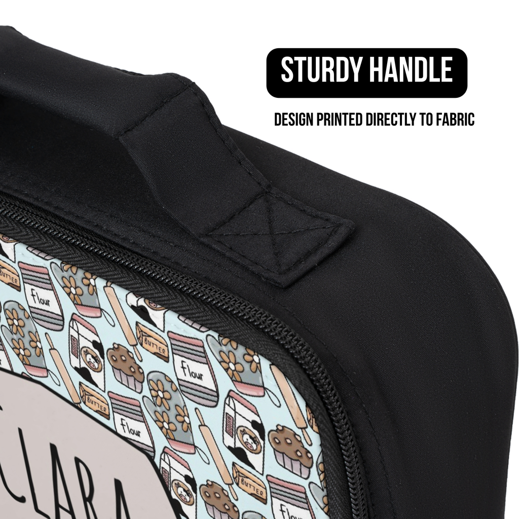 Black lunch bag with a baking pattern  handle and text indicating 'Sturdy Handle' and 'Design Printed Directly to Fabric'.