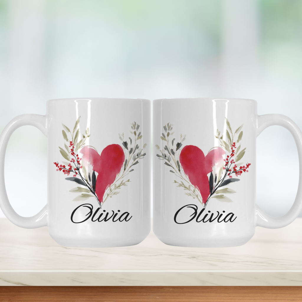 Two white mugs with a red heart and green leaves design, featuring the name 'Olivia'.