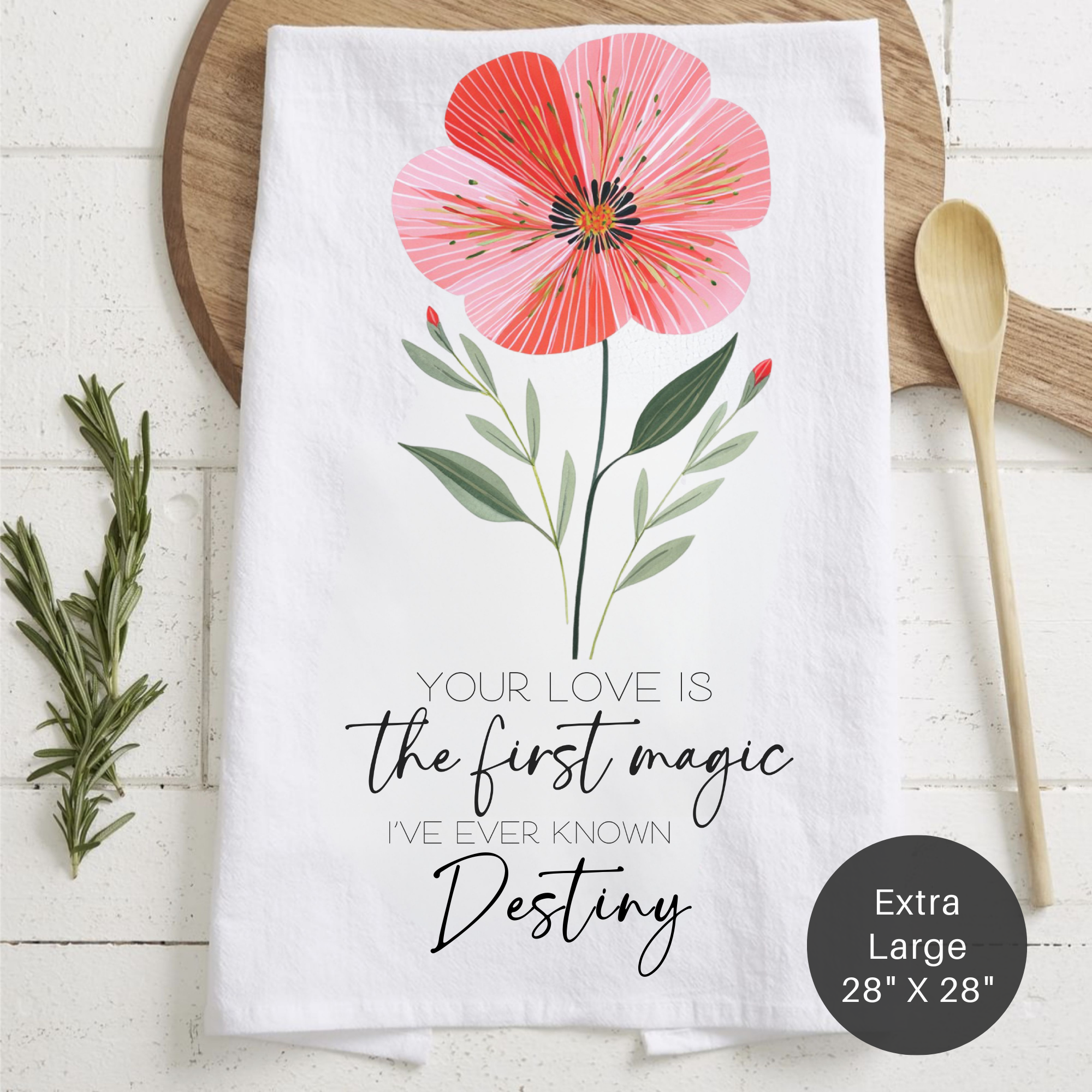 Floral-themed towel with motivational quote on a wooden surface