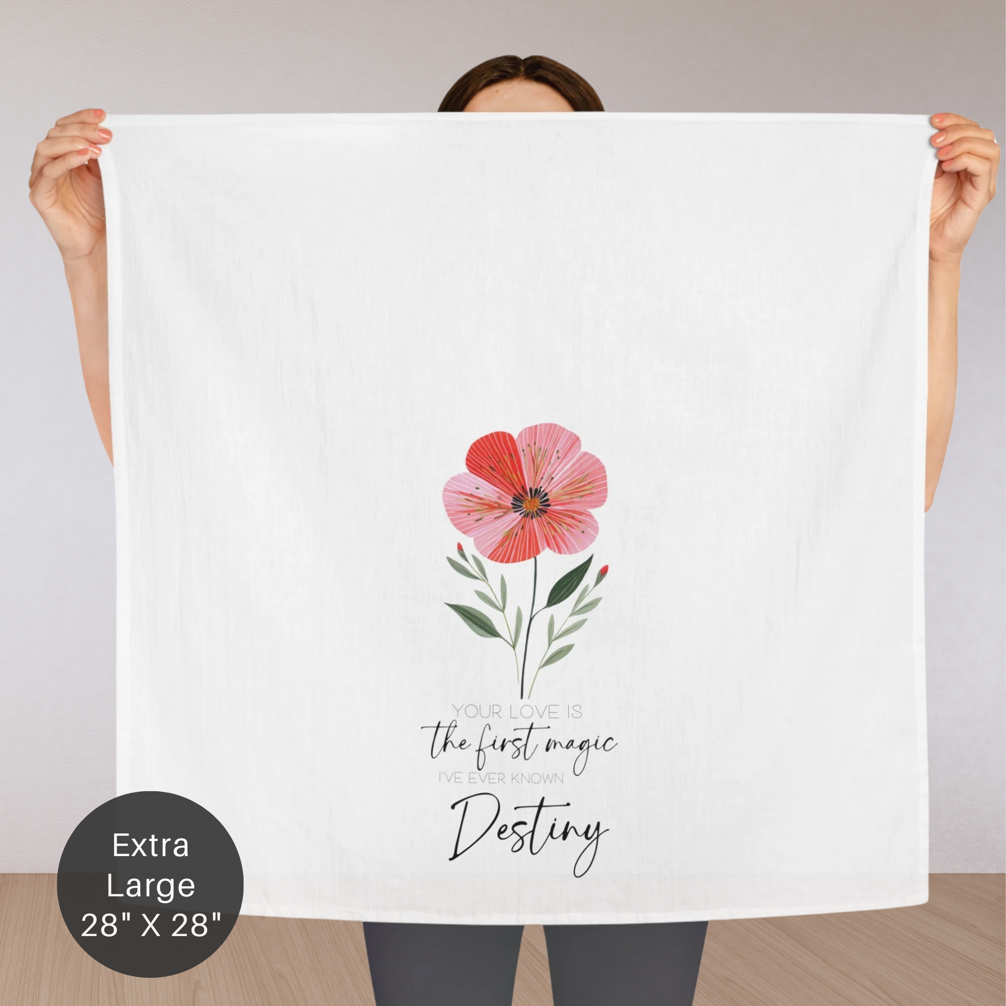 Person holding an extra large white tea towel with a pink flower design and personalized text.