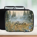 Personalized lunch bag with nature design and 'Linda' text on a blurred background