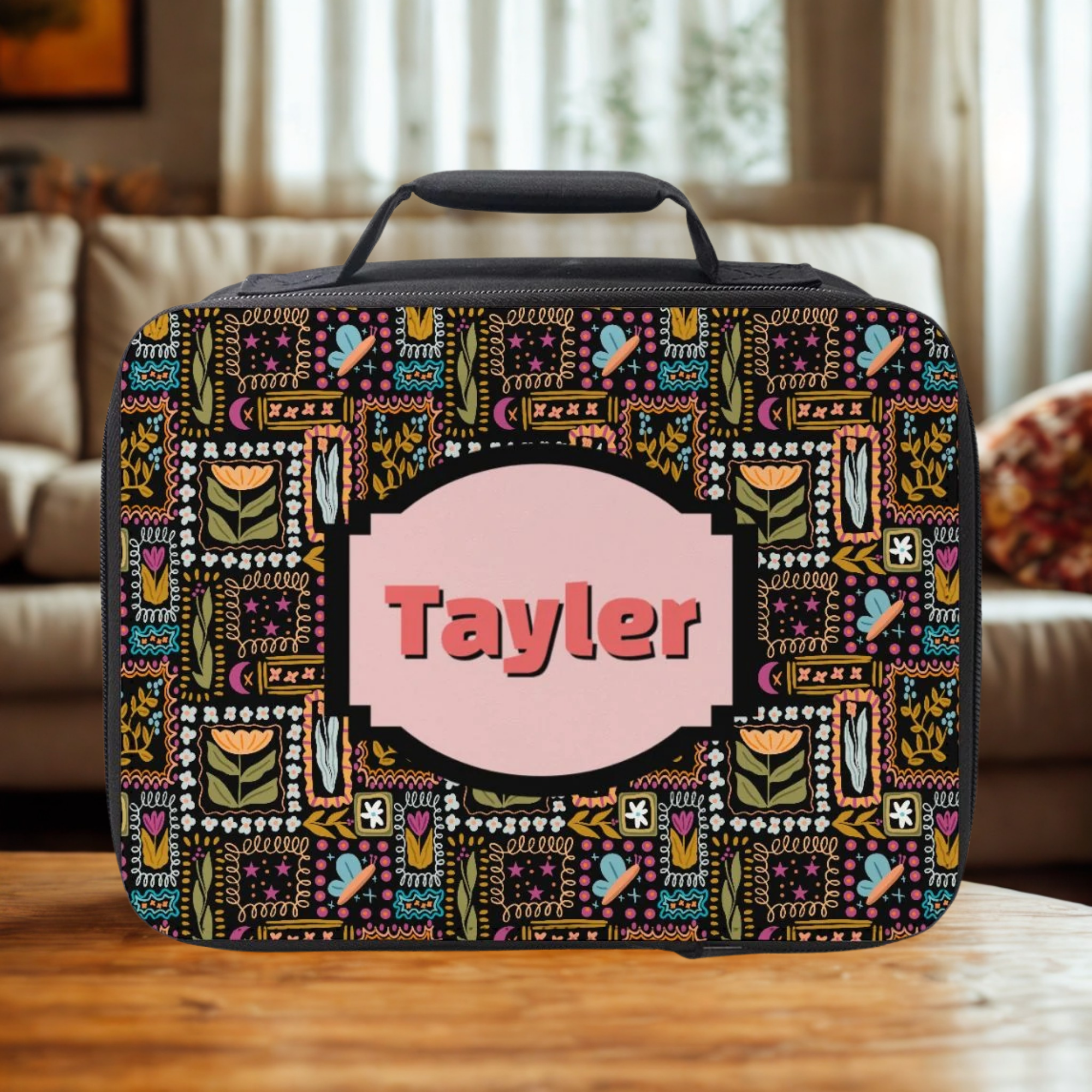 Colorful patterned bag with 'Tayler' on a wooden coffee table in a cozy living room