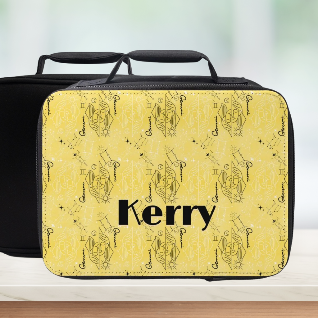 Lunch bag with yellow and  black Gemini zodiac pattern and 'Kerry' custom text on a blurred background