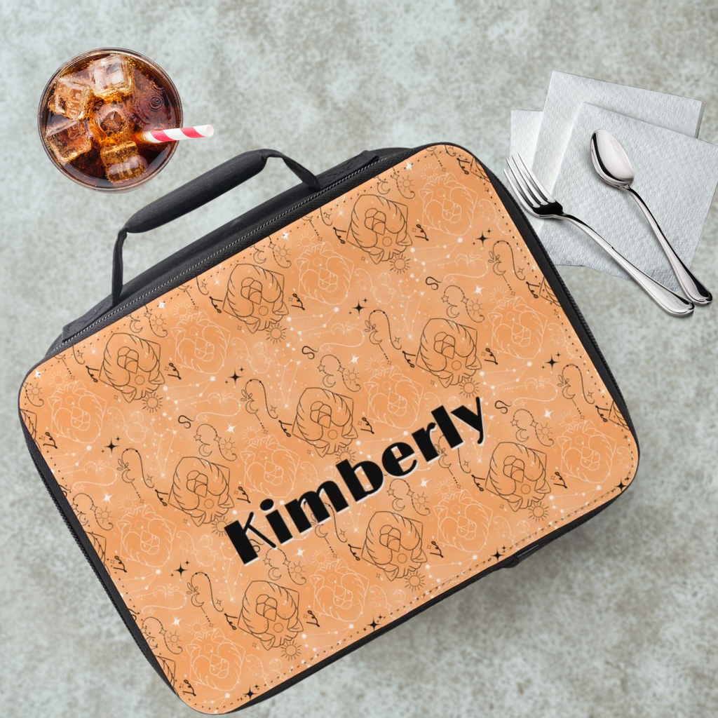 Lunch bag with Leo zodiac pattern and 'Kimberly' custom text on a cafeteria table with a drink and utensils.