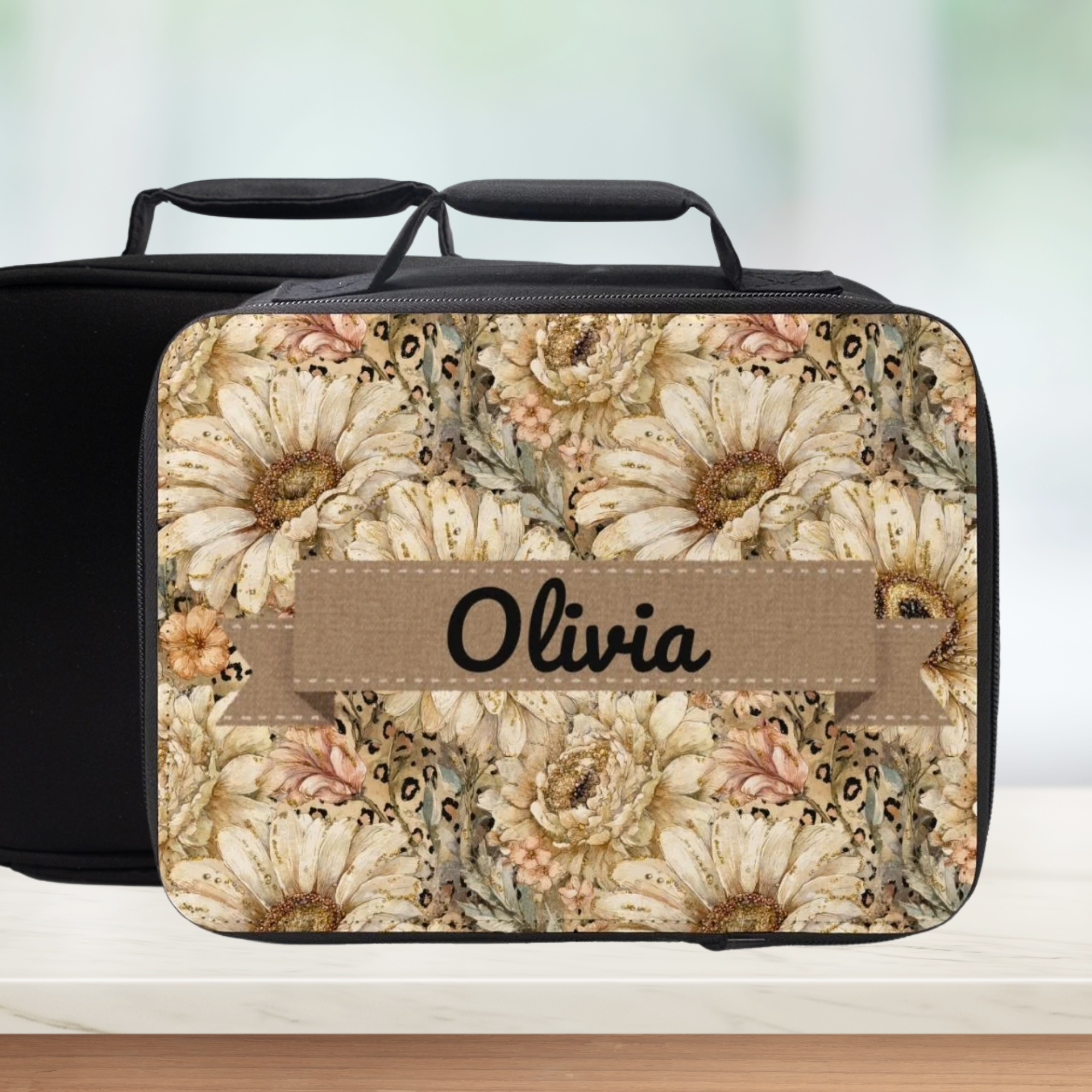 Floral patterned lunch bag with 'Olivia' custom text on a blurred background