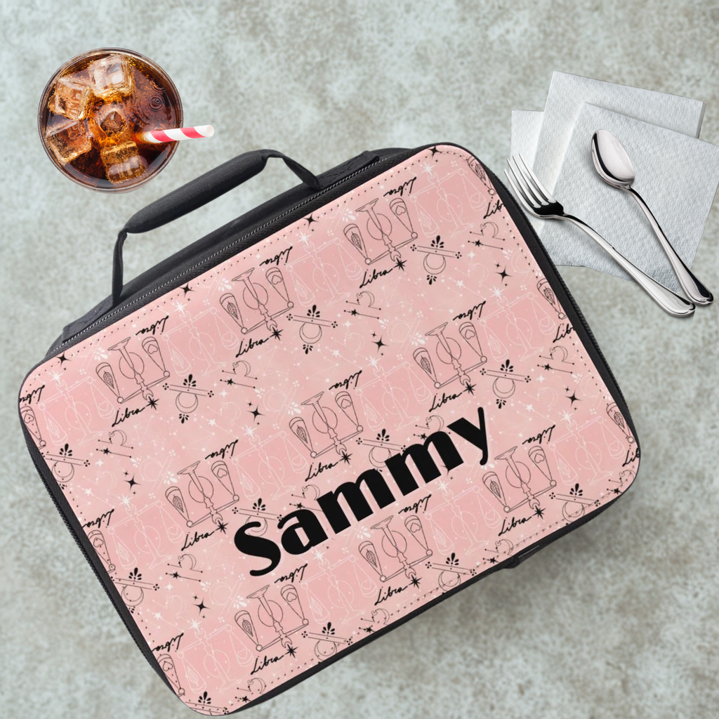 Pink Libra zodiac patterned lunch bag with 'Sammy' printed on it, placed on a cafeteria table with a drink and utensils in the background.