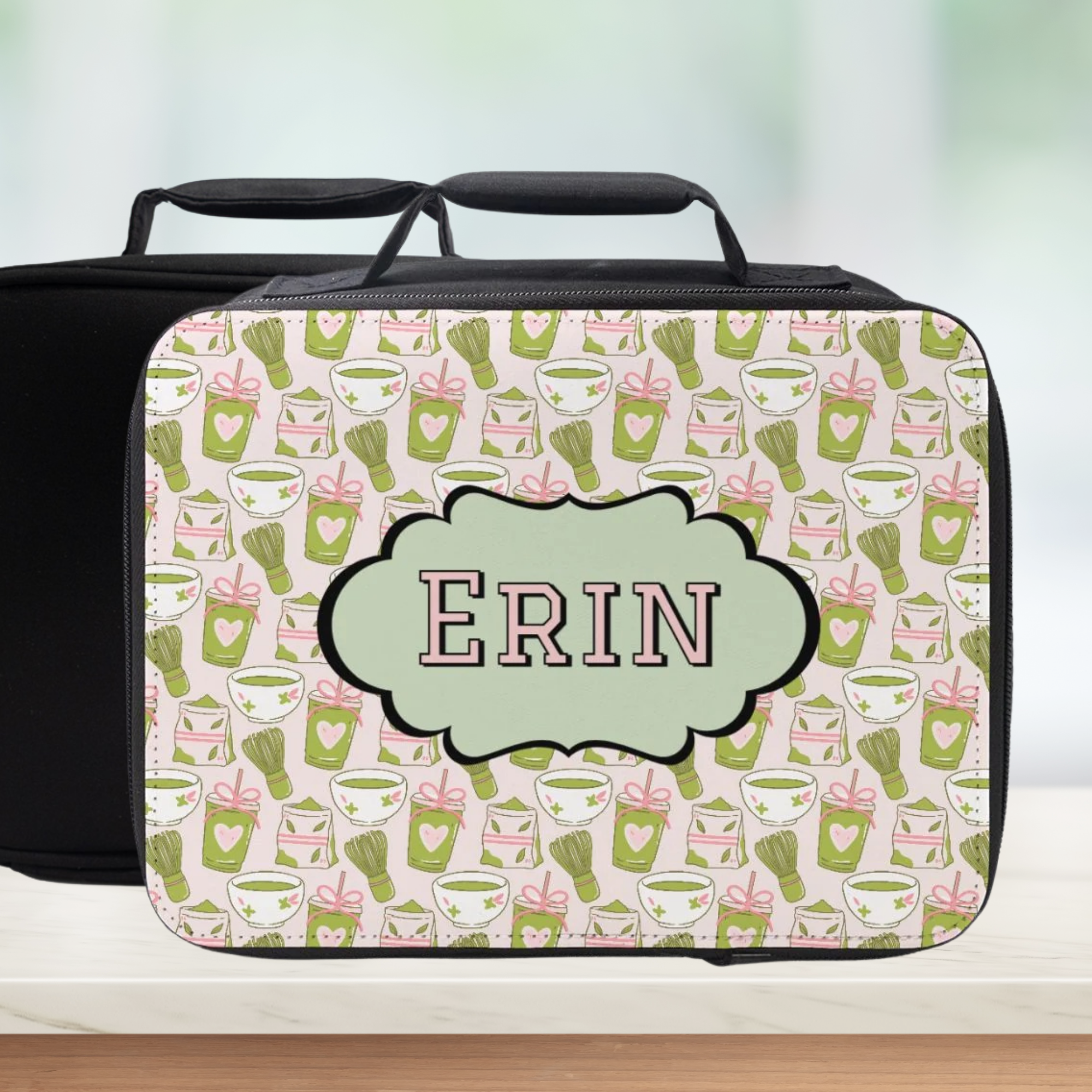 Personalized lunch bag with green and pink pattern and 'ERIN' on a light background