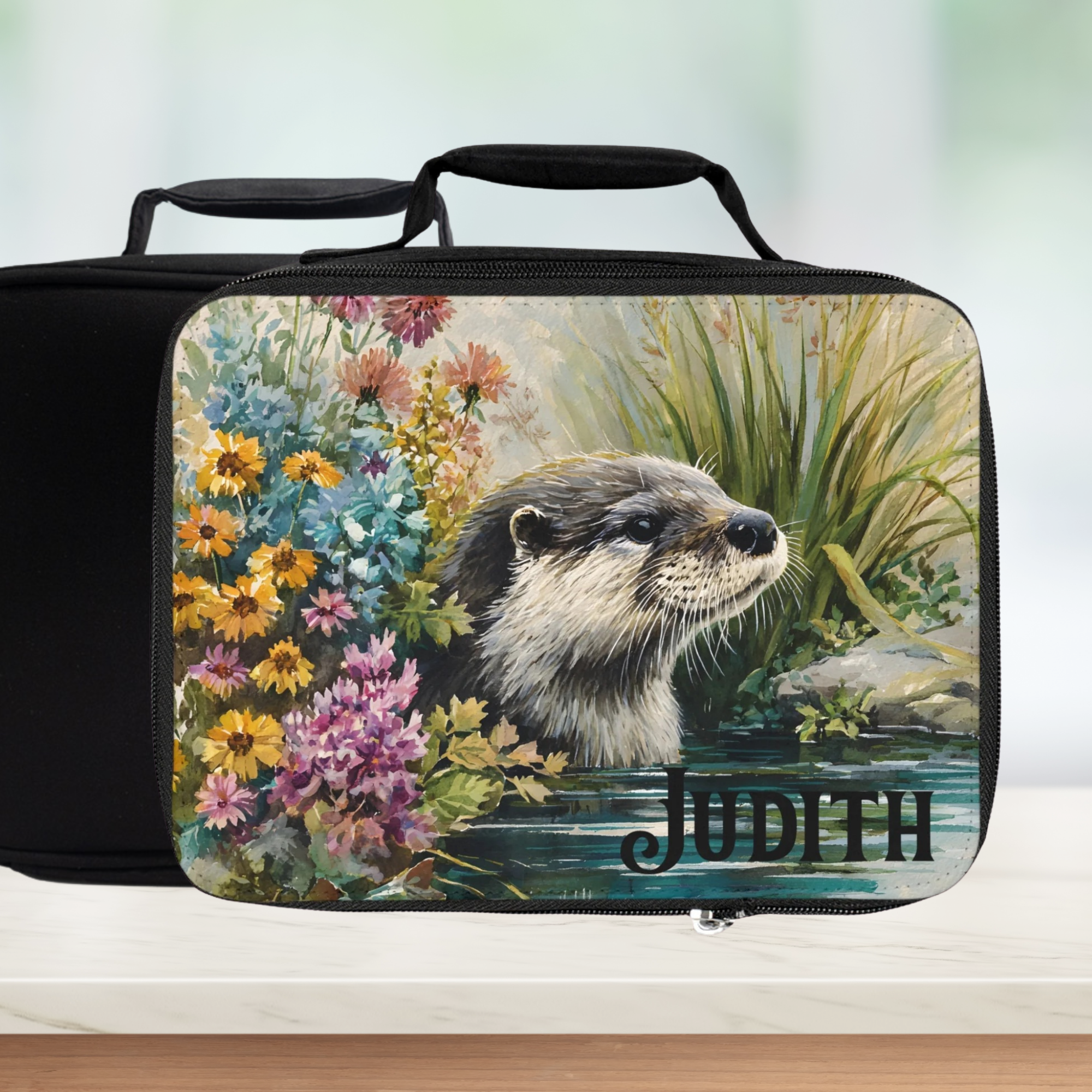  insulated lunch bag with an otter and floral design, personalized with 'Judith'.