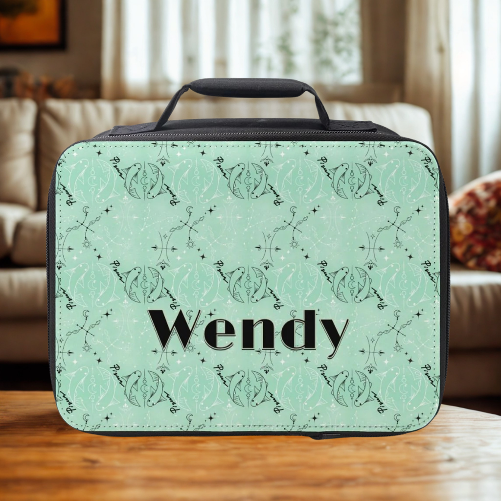 Green Pisces zodiac patterned lunch bag with 'Wendy' custom text on a wooden coffee table in a cozy living room.