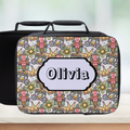 Colorful patterned lunchbox with 'Olivia' label on a wooden surface