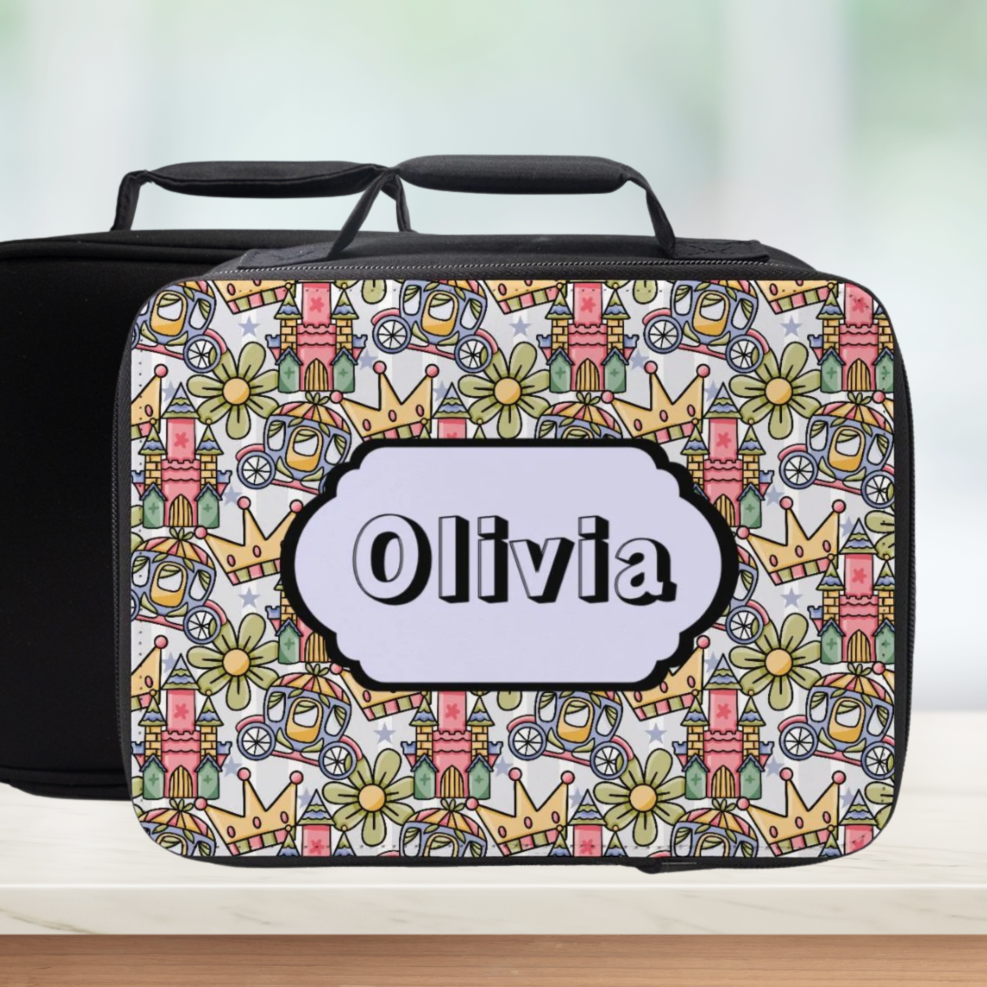Colorful patterned lunchbox with 'Olivia' label on a wooden surface