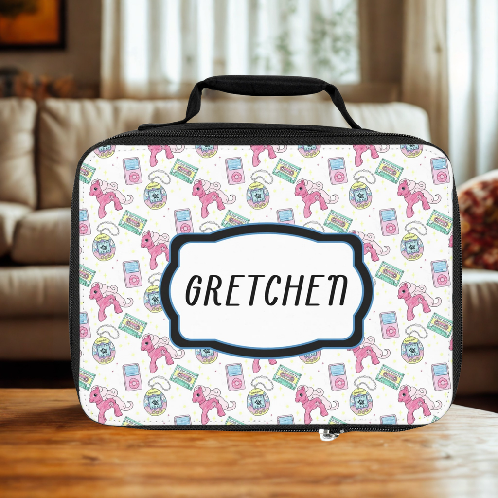  insulated lunch bag with pink 90's retro pattern and 'Gretchen' custom text on a wooden living room table.