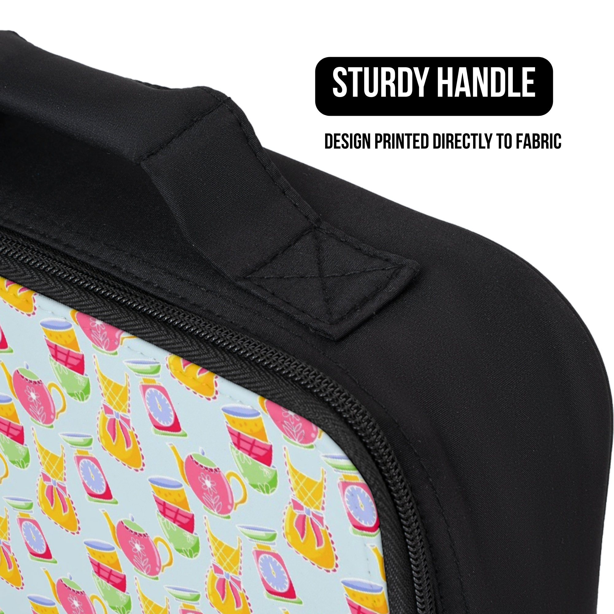 close up of a lunch bag with a colorful baking design on fabric and a black handle, labeled 'Sturdy Handle'.