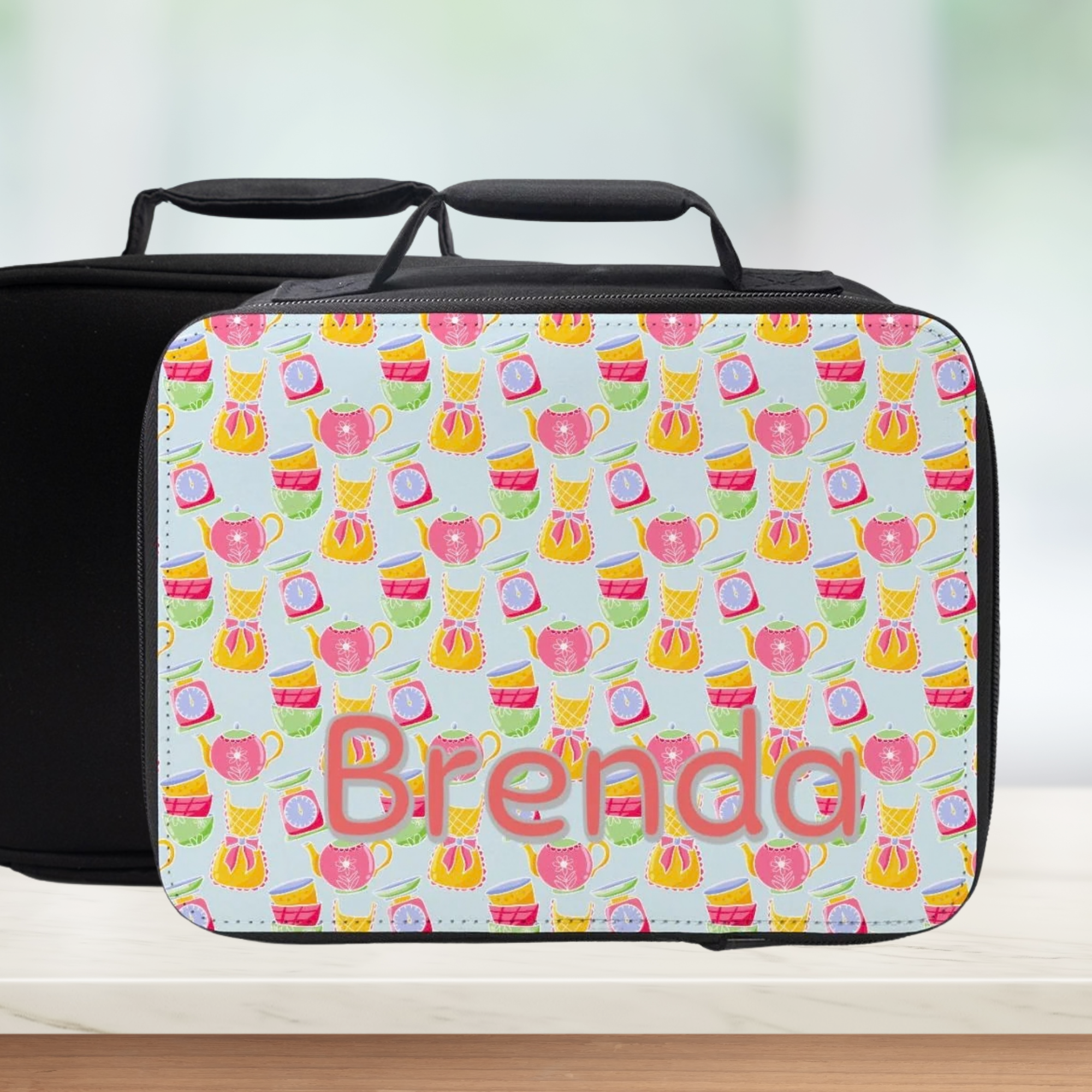 Personalized lunch bag with tea pattern and name 'Brenda' on a light background