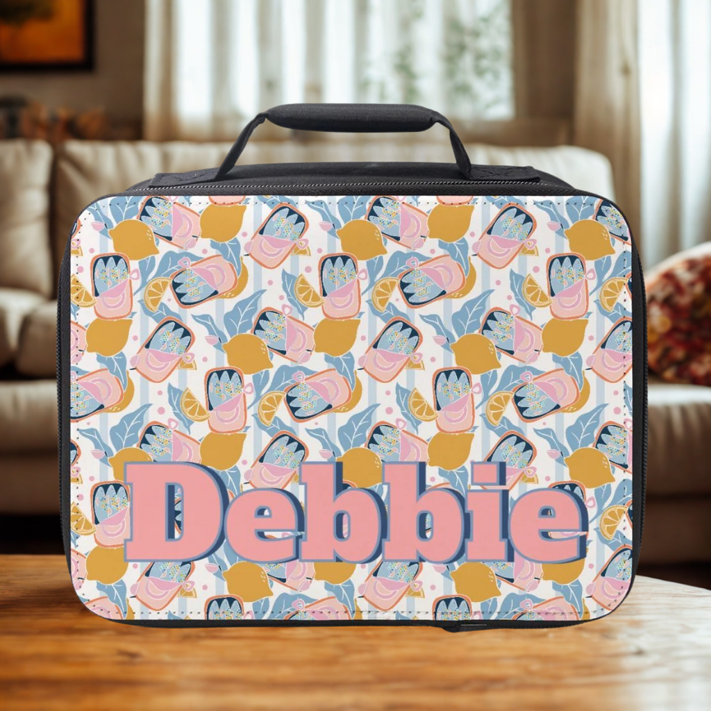  insulated lunch bag with trendy colorful sardine lemon pattern and 'Debbie' personalized text on a wooden coffee table in a cozy living room.