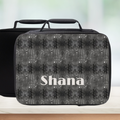 Black and gray Scorpio patterned lunch bag with 'Shana' personalization on a blurred background