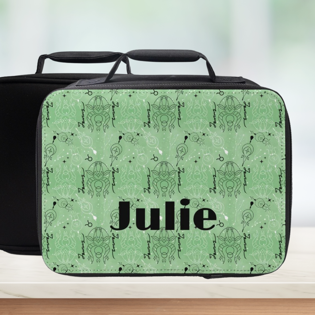 insulated lunch bag with Taurus zodiac pattern design and 'Julie' custom text on a counter with light background.