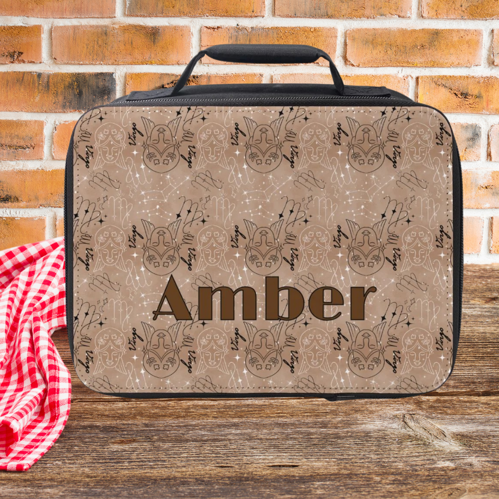  insulated lunch bag with Virgo zodiac pattern and  'Amber' custom text on a wooden picnic table against a brick wall background
