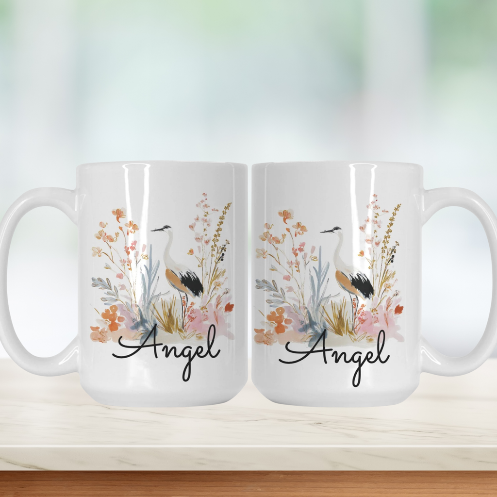 Two white mugs with floral and bird design on a light background