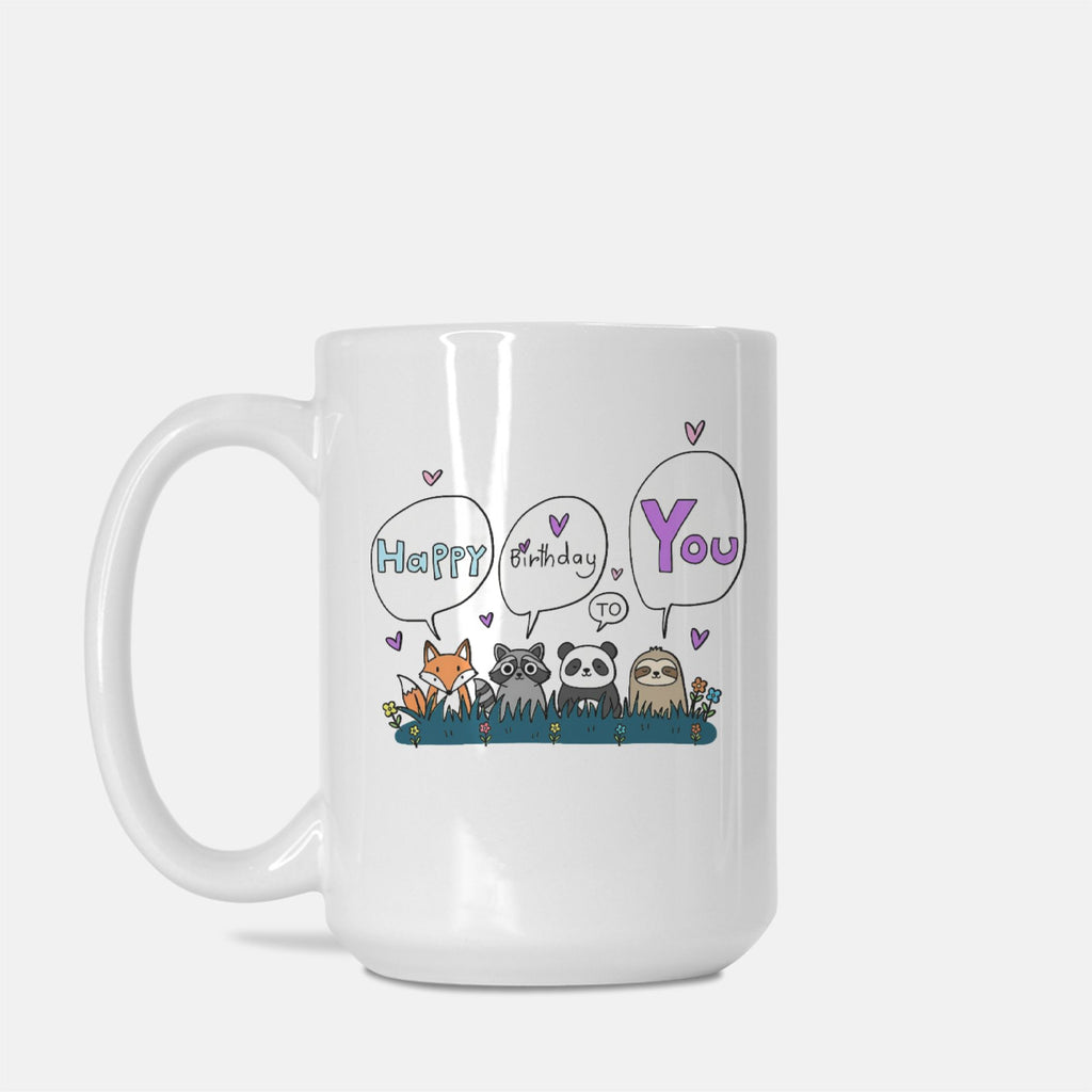 White mug with cartoon animals and 'Happy Birthday to You' text on a white background