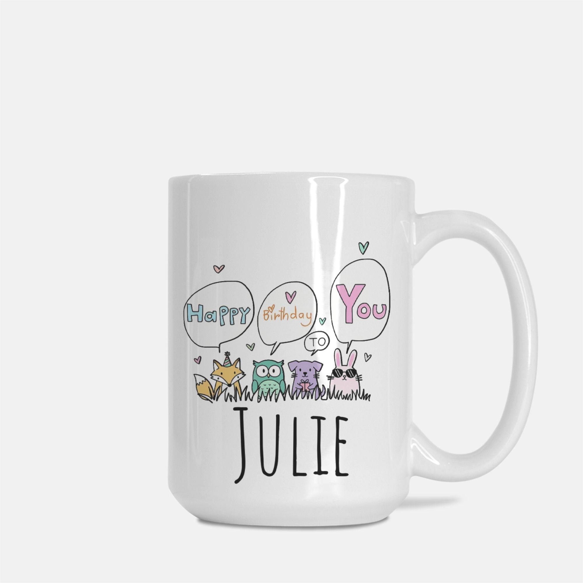 White mug with cartoon animals and text 'Happy Birthday You' to Julie on a white background