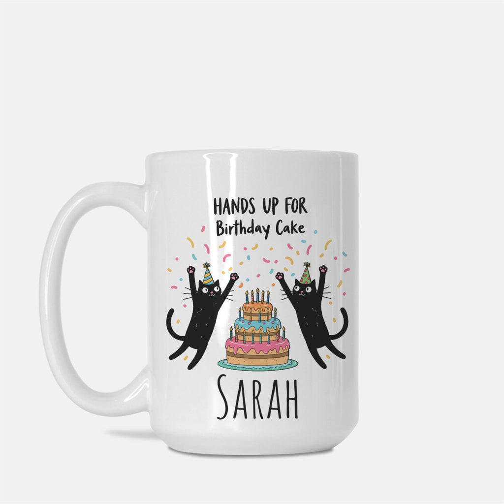 White mug with black cats and birthday cake design on a white background