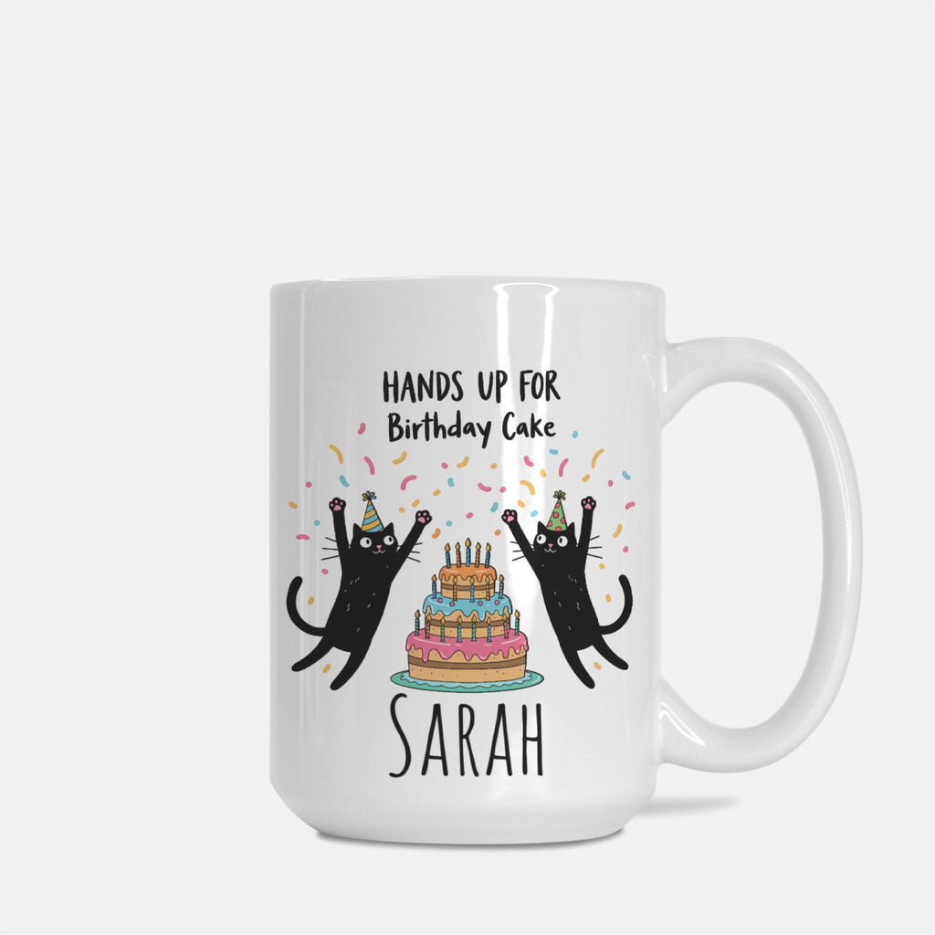 White mug with black cats and birthday cake design on a white background