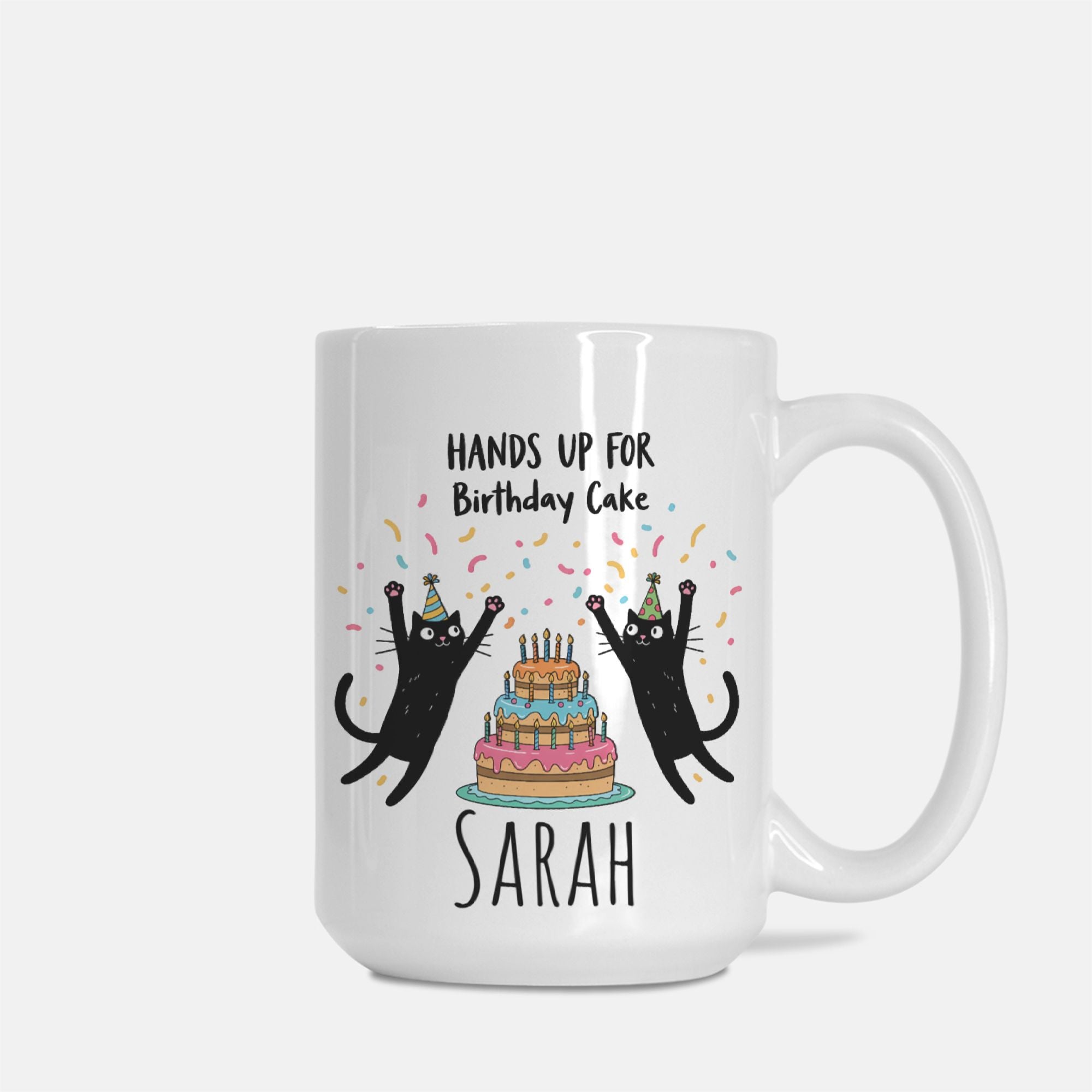 White mug with black cats and birthday cake design on a white background