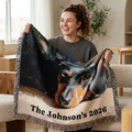 woman holding a woven blanket with an image of a black and brown dachshund dog with personalized text.