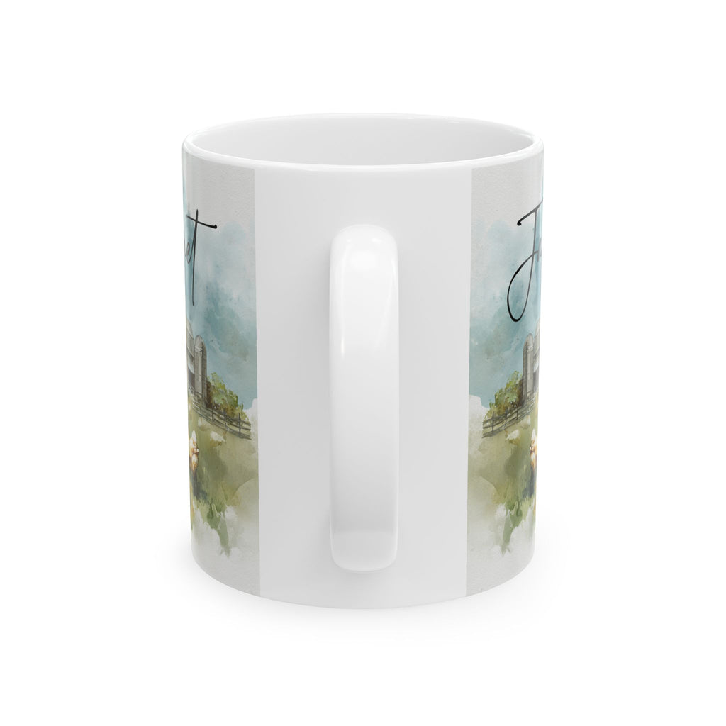 White mug with a scenic design of a field and trees, and a chicken on a white background