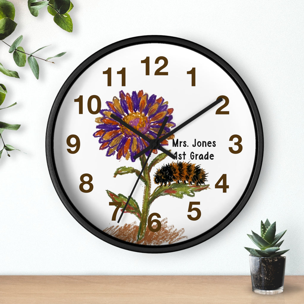 Black wall clock with a floral design and text on a white background