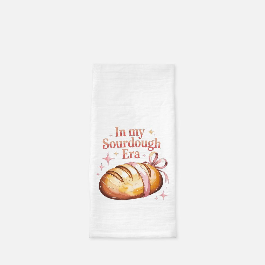 Tea towel with a loaf of bread graphic and text 'In my Sourdough Era' on a white background