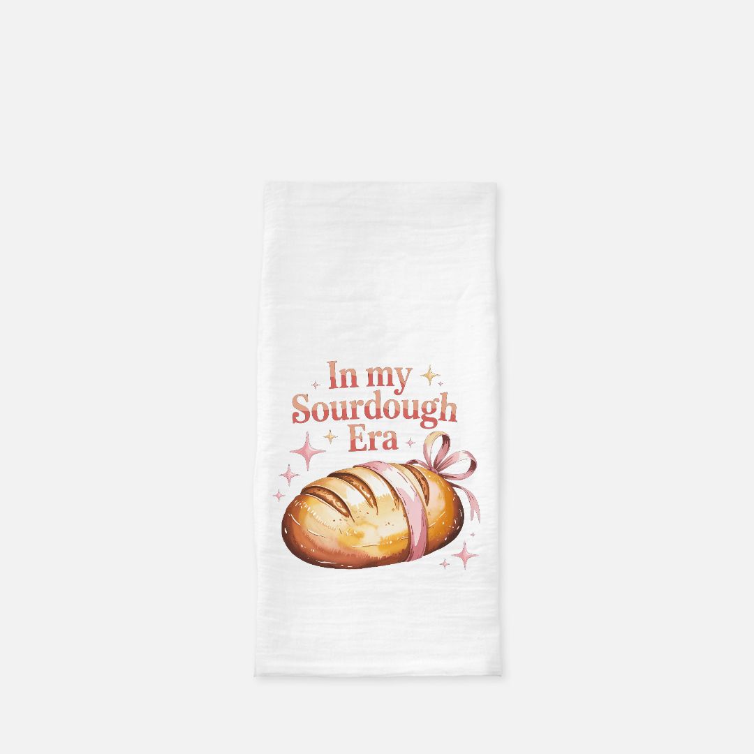 Tea towel with a loaf of bread graphic and text 'In my Sourdough Era' on a white background