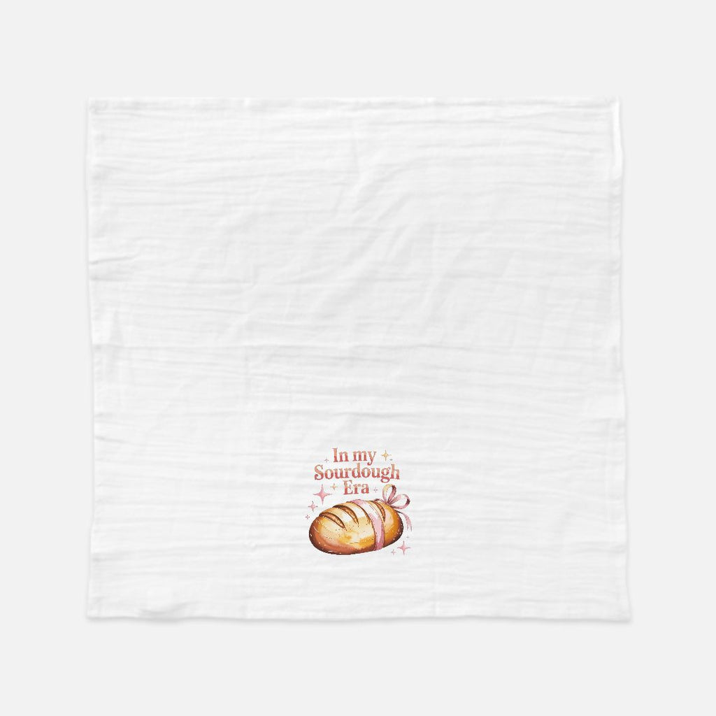 White towel with bread design and text on a white background
