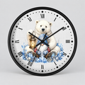 A round wall clock with a black frame and a white face featuring a printed illustration of a polar bear sitting in a sleigh with blue floral accents and a lantern. The clock has black Roman numerals and black hands, photographed against a light gray studio background.