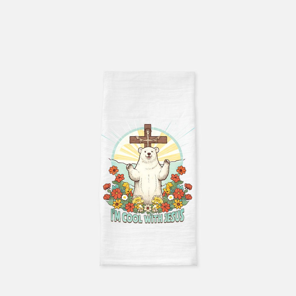 White tea towel with a polar bear holding a cross and flowers design on a white background