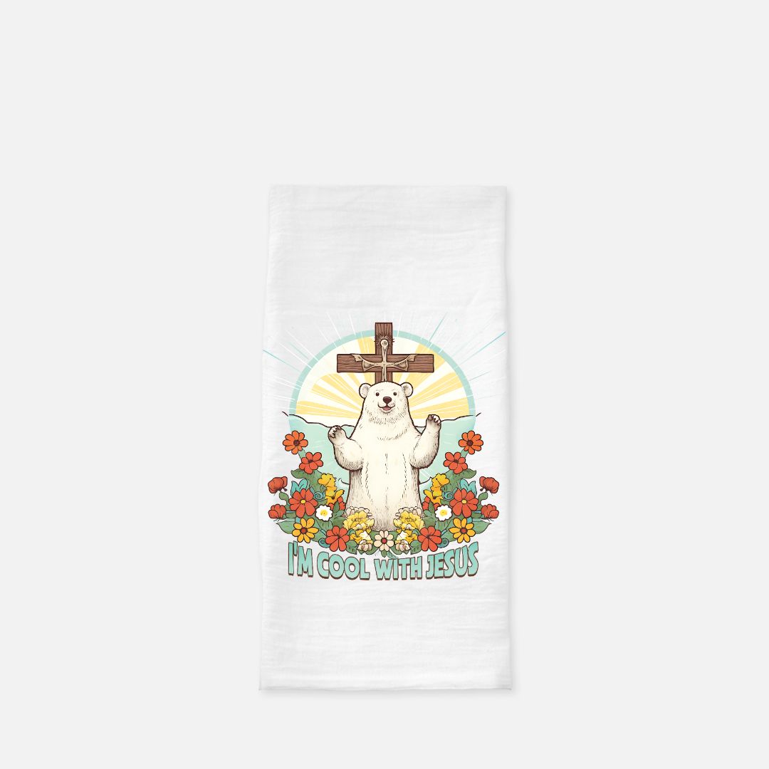 White tea towel with a polar bear holding a cross and flowers design on a white background