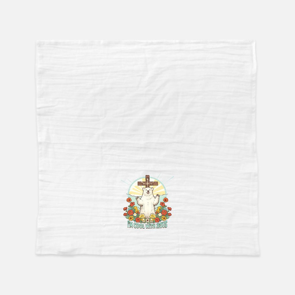 White tea towel with a cartoon polar bear in front of  a cross and flowers design on a white background