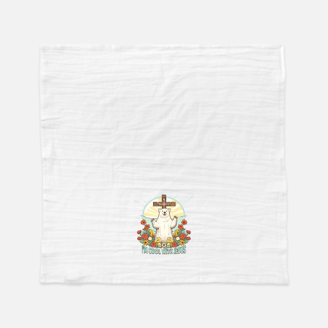 White tea towel with a cartoon polar bear in front of  a cross and flowers design on a white background