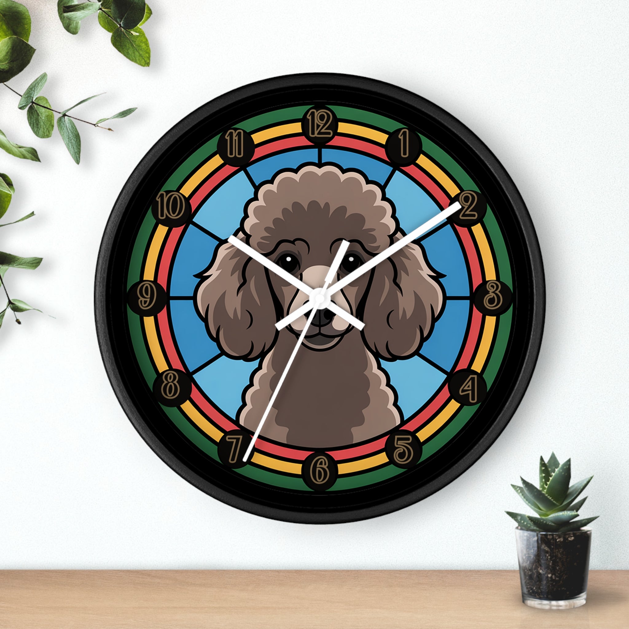 Wall clock with a Poodle dog illustration on a colorful background, placed on a wooden surface with plants.