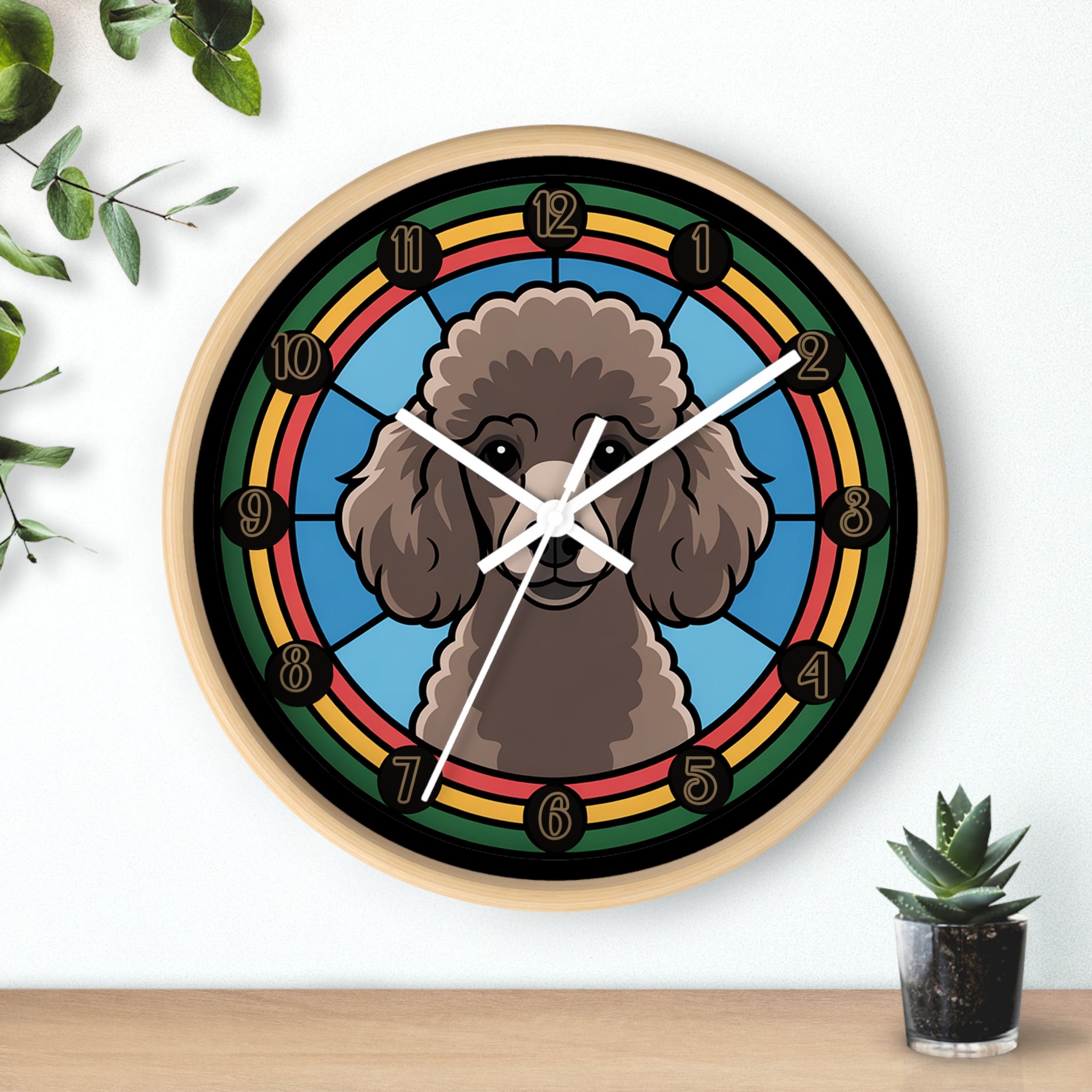 Wall clock with a poodle dog illustration on a colorful background, placed on a wooden surface with plants.