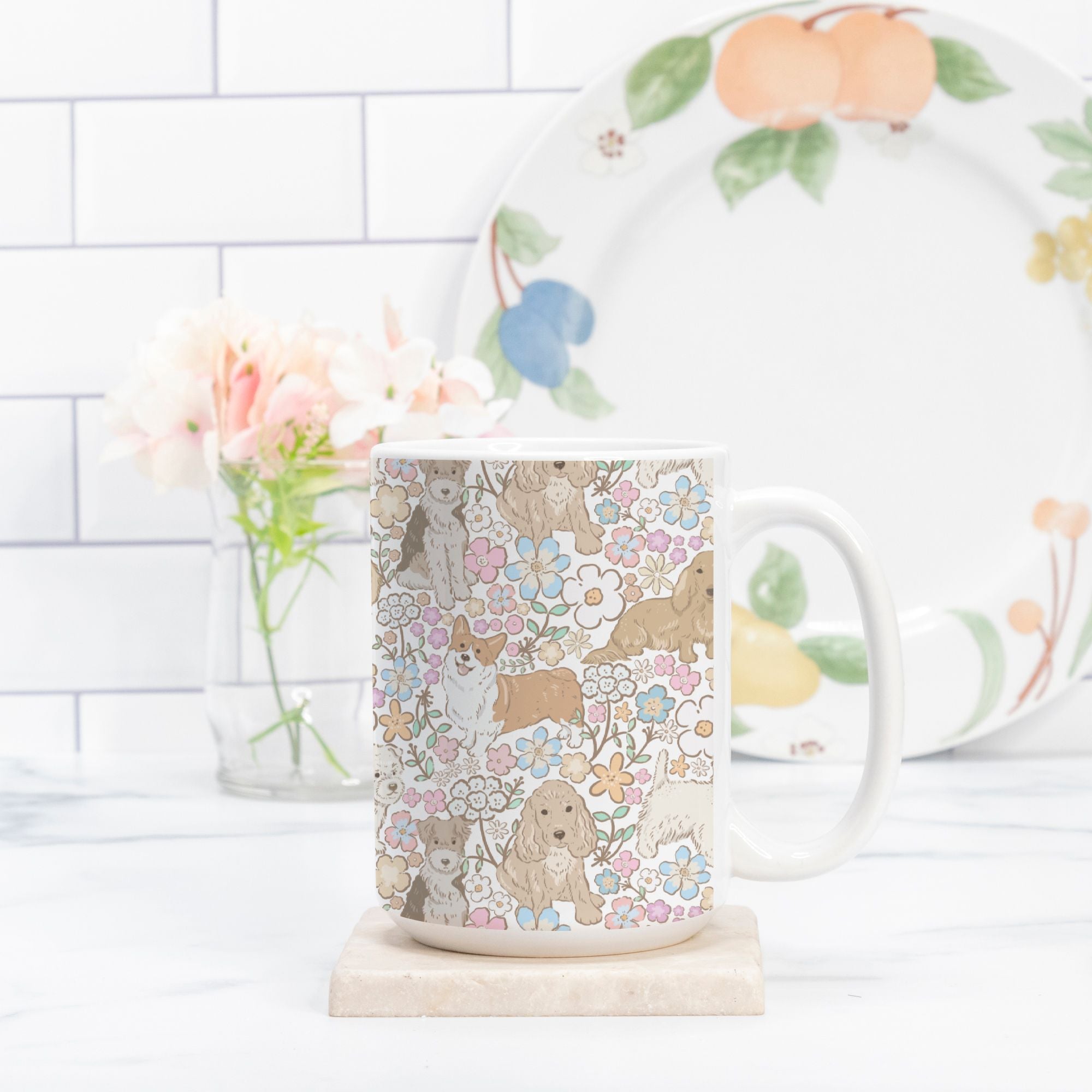 Mug with dog and floral pattern on a marble coaster, with a plate and flowers in the background.